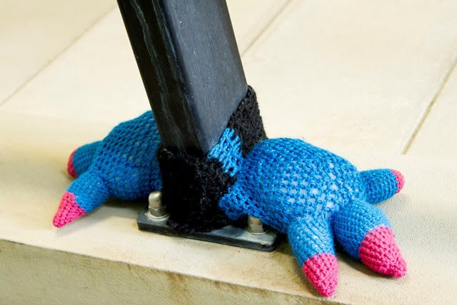 dinosaur feet yarn tied to hand rail